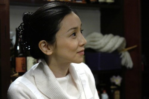 A woman at a small restaurant